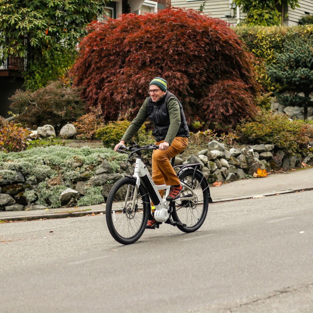 A man riding an electric bike down a street