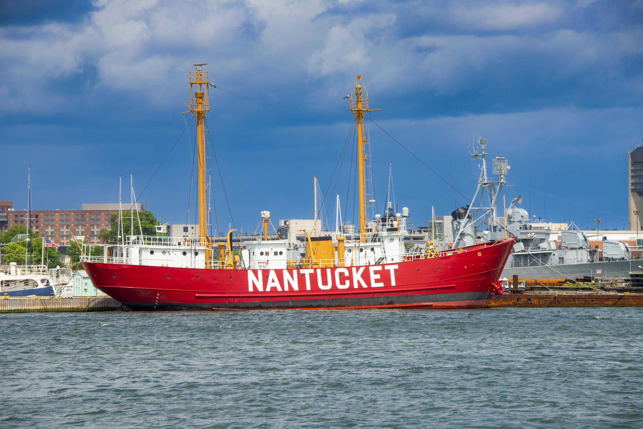 Red and White Historical Ship on Harbor Under Blue Sky