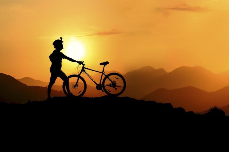 Silhouette Photography of Biker on Top of Hill