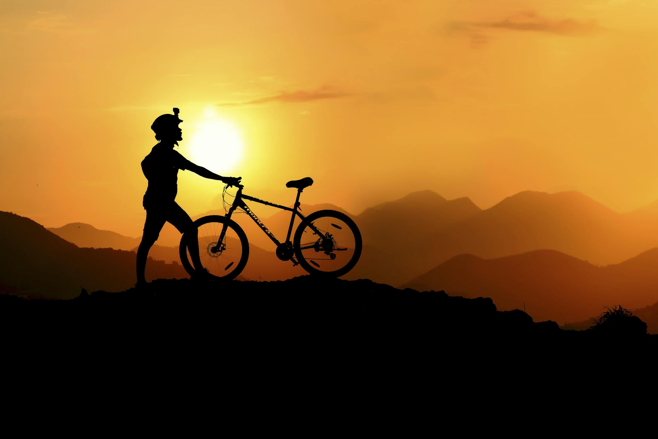 Silhouette Photography of Biker on Top of Hill