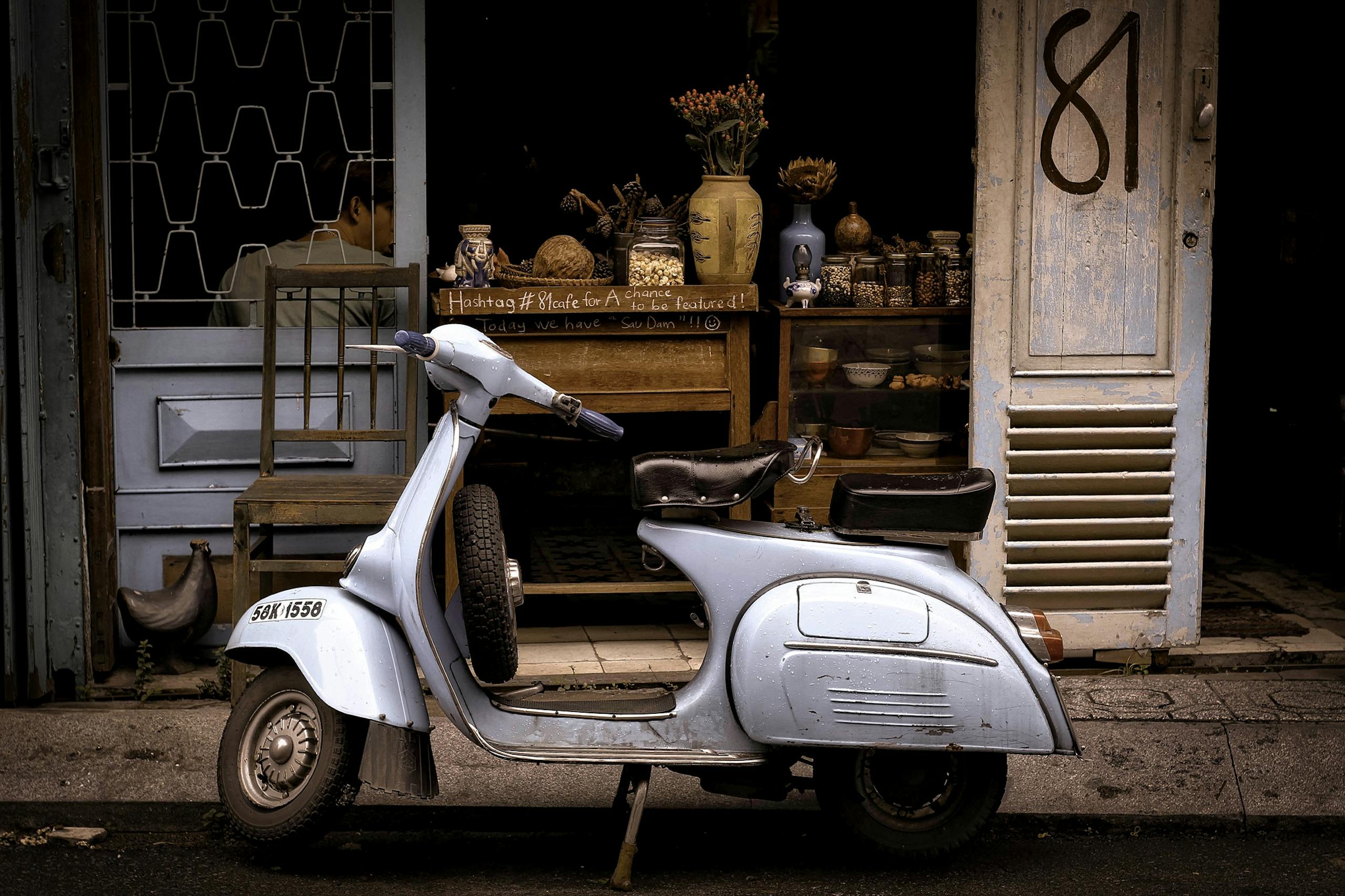 White and Black Motor Scooter Parked Near Building