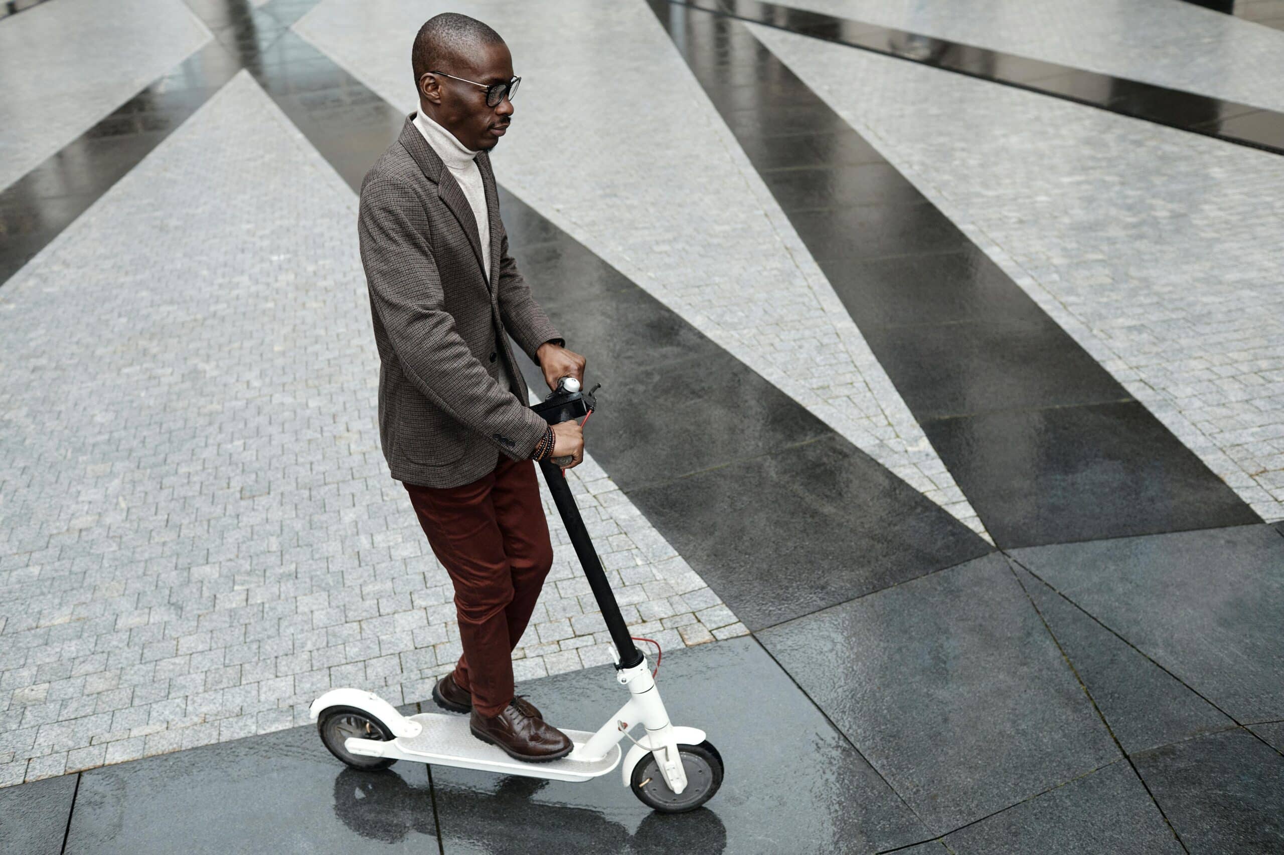 man riding a white scooter